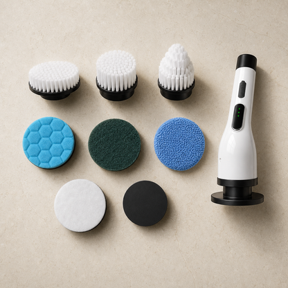 White electric spin scrubber and interchangeable attachments arranged on a light studio surface