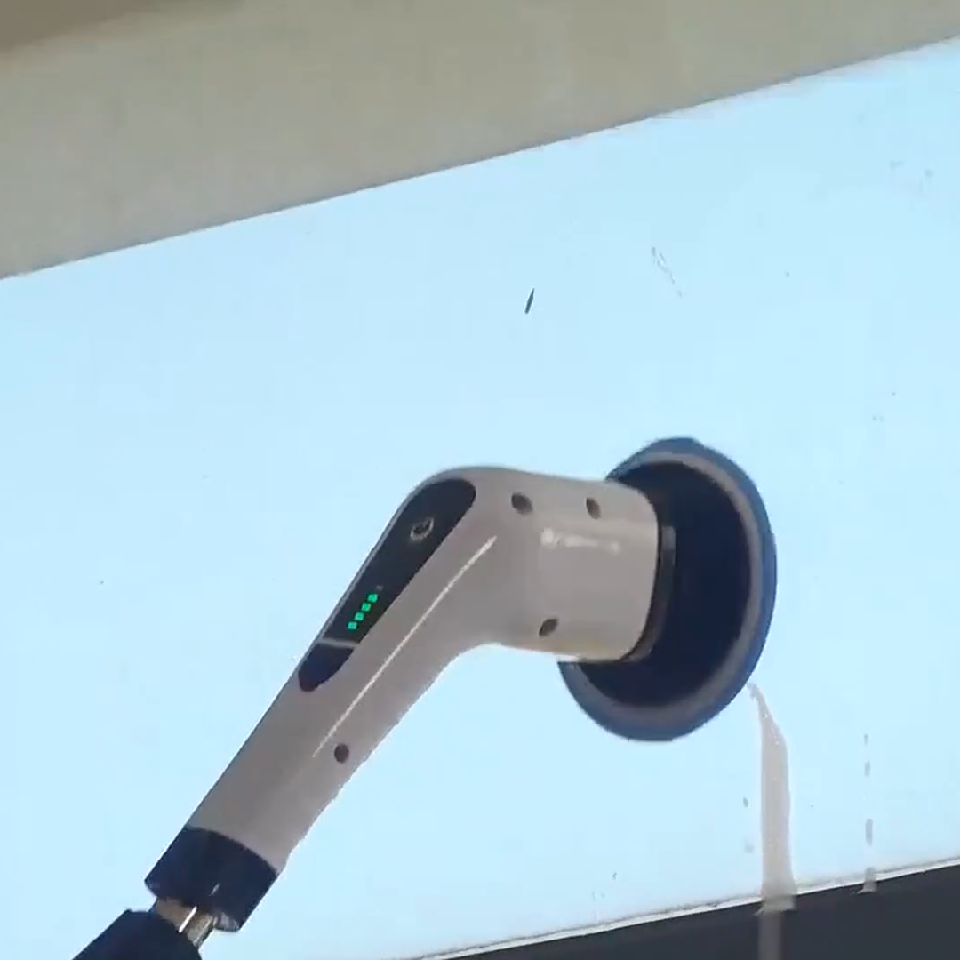Close view of the exact electric scrubber contacting a glass surface