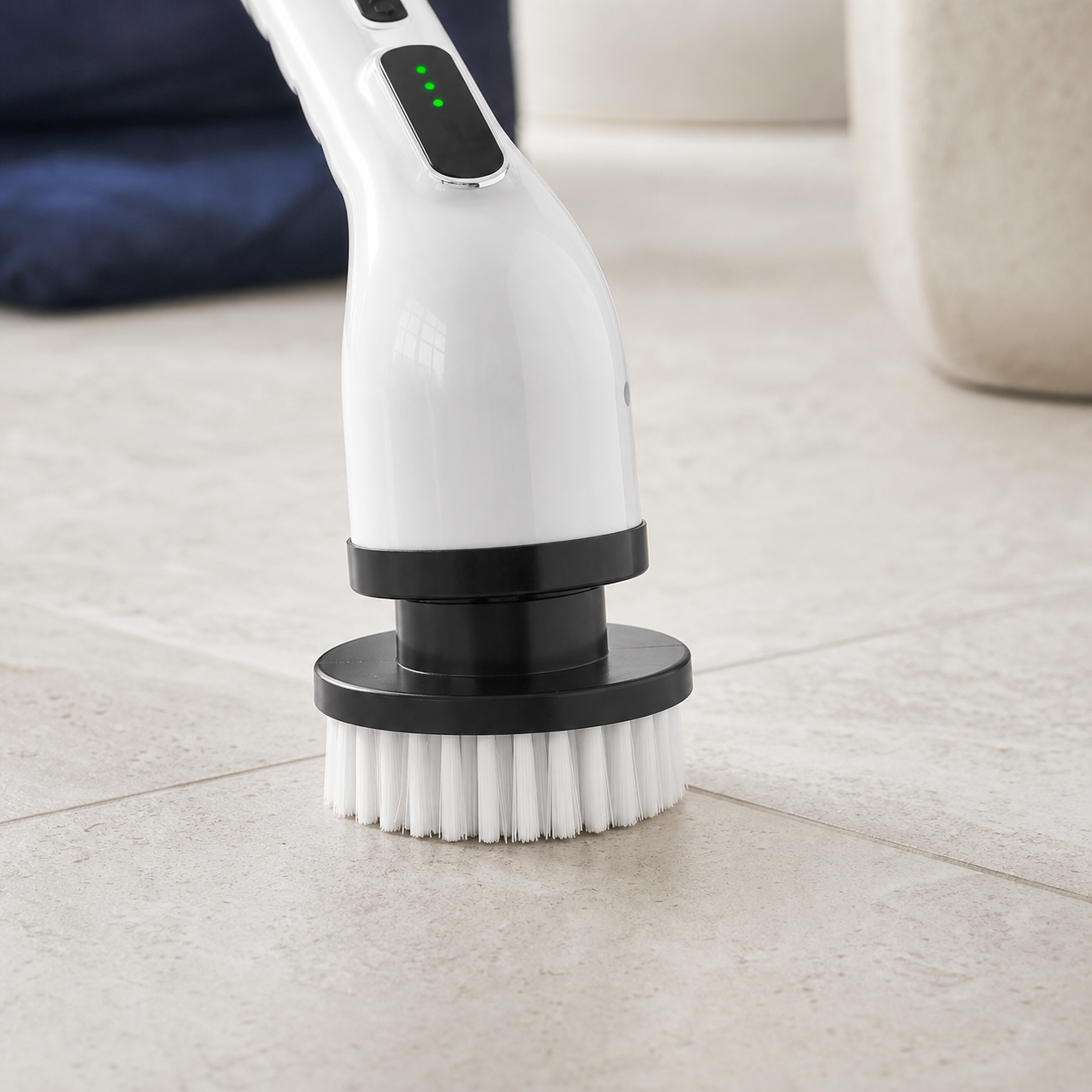 Close view of the round cleaning head attached to the white electric scrubber